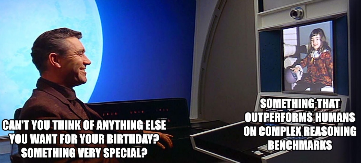 A meme-style still from 2001: A Space Odyssey shows a man seated at a futuristic video console, smiling as he speaks to a child on a screen. Overlaid text on the left reads, "CAN'T YOU THINK OF ANYTHING ELSE YOU WANT FOR YOUR BIRTHDAY? SOMETHING VERY SPECIAL?" Overlaid text on the right, next to the child’s image, reads, "SOMETHING THAT OUTPERFORMS HUMANS ON COMPLEX REASONING BENCHMARKS."