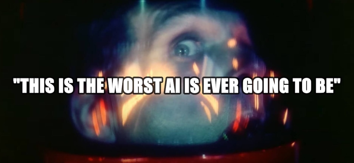 A blurred, dramatic close-up of a wide-eyed astronaut inside a helmet, lit by reflections and glowing lights, with bold white Impact-style text across the center reading, "THIS IS THE WORST AI IS EVER GOING TO BE."